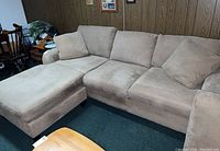 Max Home sectional sofa with chaise lounge in beige microfiber, showing full length and cushions in basement setting.