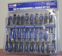 Front view of the 100-piece screwdriver and driver bit set in original blister packaging showing all included screwdrivers and bits with GRIP branding.