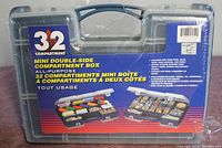 Front view of the 32 compartment double-sided storage box in its original packaging with label and product details.