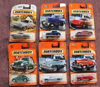 Six unopened Matchbox die cast cars in original packaging with orange Matchbox branding and detailed images of each car model.