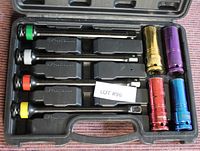 Four torque wrenches with color-coded handles and six anodized metric sockets in a hard plastic case.