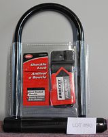 Front view of Bell shackle lock in packaging showing label with brand, shackle type, and included mounting bracket.
