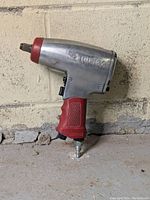 Photo of the Husky 1/2" impact wrench showing the left side with markings and red textured grip.