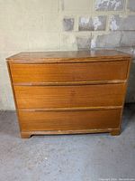 Front view of the MCM style 3-drawer wooden dresser showing overall condition and design.