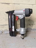 Side view of the Porter Cable BN200SB brad nailer showing the air pressure fitting and overall condition.