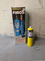 Photo of boxed Pyro 5 welding torch standing on the floor next to a yellow gas cylinder.