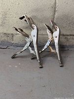 Side view of both Vise Grip clamps standing upright showing jaws and handles.