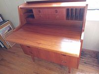 Front view of desk closed, showing three bottom drawers and integrated handles