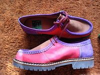 Side and top view of one shoe showing pink and purple leather panels with laces.