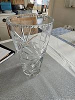 Front view of crystal clear vase showing pinwheel cut pattern and scalloped rim