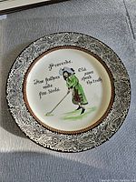 Front view of the Royal Doulton decorative plate with a golf-themed design and humorous text.