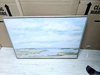 Full view of the framed landscape and water print showing the artwork and metallic frame.