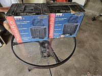 Photo of the two original boxes of Seabreeze Thermaflo portable space heaters on a glass table, showing box condition and branding.