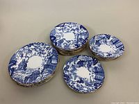 Overview of all stacked plates and bowls, showing set composition and gold rims