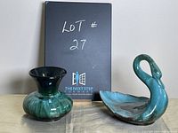 Front view of swan figurine and vase side by side showing colors and glaze finish