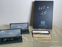 Lot includes four boxed Cross pens, two in dark green velvet-lined cases, two in cream and black boxes.