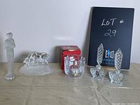 Lot display showing frosted glass figurine, crystal horse sculpture, small clear glass bowl, and two crystal perfume bottles with stoppers.