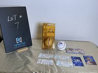 Photo of entire lot with unopened Baseball Hall of Fame baseball in yellow packaging, additional white baseball with black logo, several tickets including 1995 Blue Jays and Jackson Family concert tickets laid out on table