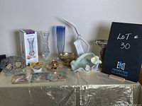 Photo of an assortment of decorative vases, sculptures, candle holders, and small decorative pieces.