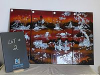 Set of four lacquer panels arranged side by side showing connected scene in shades of red, orange, and silver.