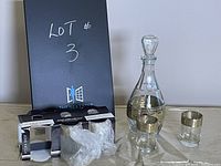 Full set with black lot sign, sealed boxes of shot glasses, decanter and shot glasses outside boxes showing gold geometric trim