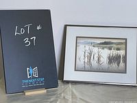 Photo of the framed art print with a black backing showing lot number 37.