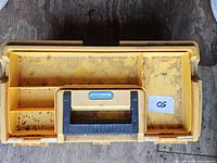 Closed yellow plastic toolbox showing wear and Nestopact label