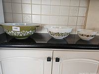 Front view of three Corelle bowls showing floral patterns and different sizes.
