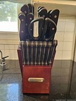Front view of the wooden knife block filled with knives and scissors, showing the Faberware logo.