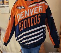 Front view of Denver Broncos coat showing team logos and colors