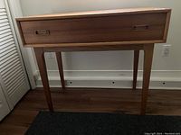 Front view of teak desk with drawer closed