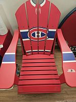 Front view of red folding Adirondack chair featuring Montreal Canadiens logo and stripes
