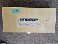 Closed wooden case labeled 'Mastercraft Forstner Bit Set' with handwritten label on lid.
