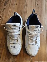 Top view of white New Balance 608 shoes showing laces and tongue branding.