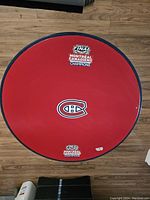 Top view of the round tabletop showing red paint with Montreal Canadiens logo and stickers.