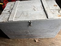 Front view of large white pine wooden box painted white, showing latch and wooden construction.