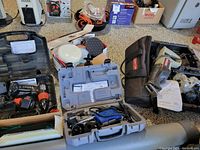 Wide view showing all tools and cases in the lot arranged on the floor