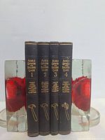 Front spines of all four volumes showing title, volume number, topics and tool illustrations in gold embossing