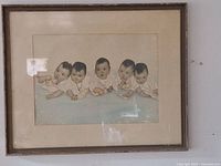 Full image of the framed print showing the Dionne quintuplets and original framing.