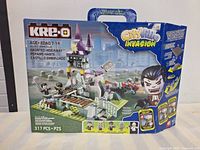 Back and side view of the sealed KRE-O Haunted Hideaway set box showing the design, mini-figures included, and piece count.