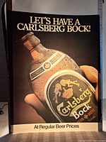 Full view of the Brewers Retail lighted advertising insert with a Carlsberg Bock bottle and text 'LET'S HAVE A CARLSBERG BOCK!'