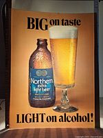 Full view of the translucent vinyl advertising insert featuring Northern Extra Light Beer bottle and full glass with condensation and frothy head, with prominent text.