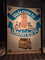 Front view of the lighted advertising insert showing a woman holding two bottles of Molson Oktoberfest beer with the text 'Welcome to Oktoberfest 84'.