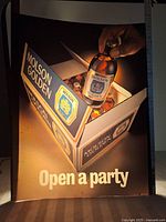 Front view of translucent lighted advertising insert showing a Molson Golden beer case with a hand holding a bottle and 'Open a party' text