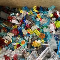 Photo showing close-up of assorted transparent LEGO pieces in red, yellow, blue, clear, and other colors.