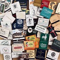 Photo showing a spread of vintage matchbooks from various Washington DC, Maryland, and Virginia establishments including restaurants, clubs, and embassies. Visible logos and names include Manor Tavern, The Chart House, Japanese Steak House, and more.