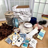 Full lot view showing various trims, yarns, sewing needles, tape measures, snaps, ribbons, pins and needle packages.