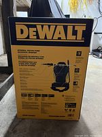 Box of DeWalt internal piston pump backpack sprayer showing front with product details and branding.