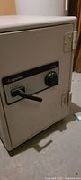 Front view of the Sentry Safe showing the combination lock dial and handle.