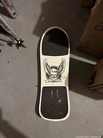 Top-side of the skateboard showing white deck with black grip pads and eagle graphic with 'Viper' text.